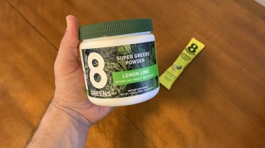 Our tester holds a container of 8Greens Super Greens Powder