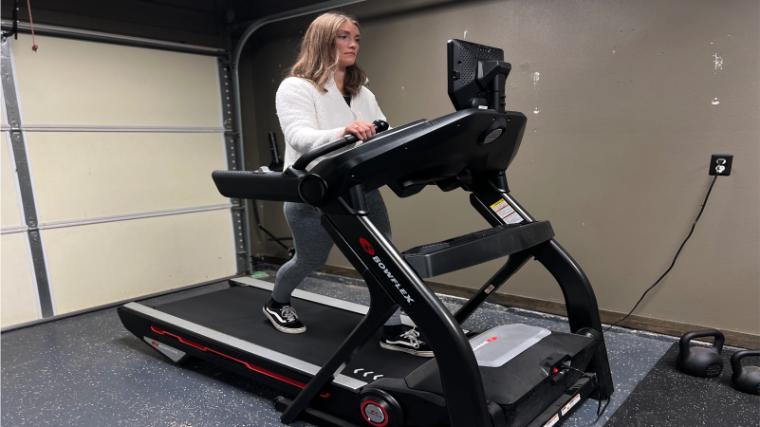 Front view of a person walking on a BowFlex Treadmill 10.