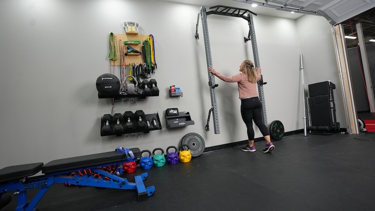 Our tester unfolding the PRx Performance Profile PRO folding squat rack