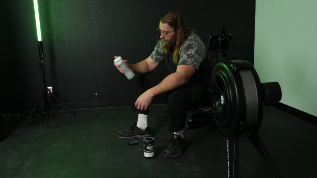 BarBend tester shaking up creatine after a workout.