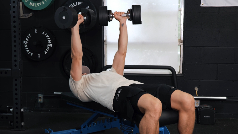 BarBend's Jake Herod bench pressing with the Snode Adjustable Dumbbells.