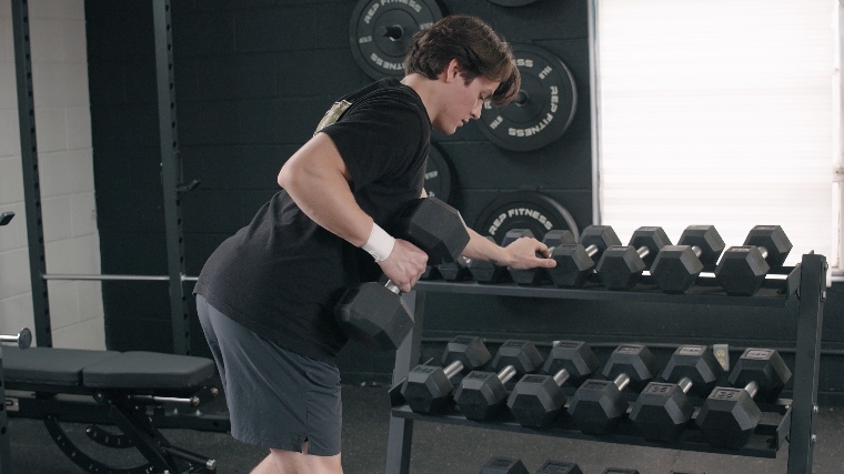 Jake Bracing Against the REP Fitness Dumbbell Storage Rack for Dumbbell Rows