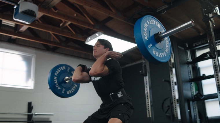 A person Power Cleaning with the Rogue Ohio Bar.