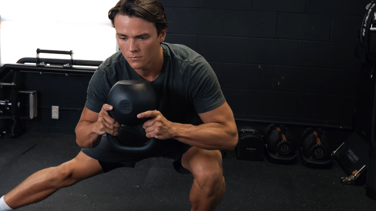 Our tester working out with the Kettlebell Kings Powder Coat Kettlebell.