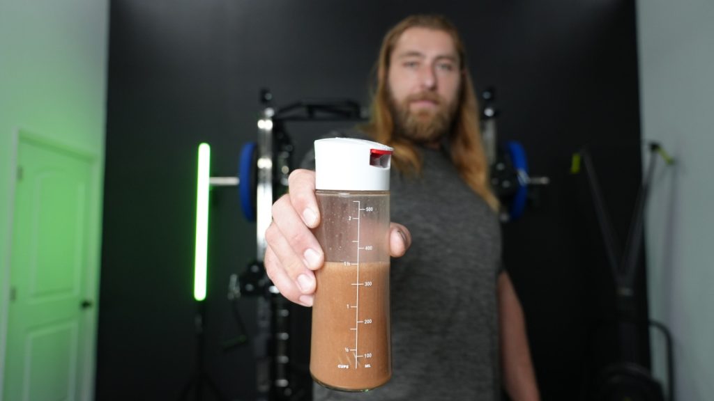 Our tester holding a shaker bottle with mixed legion whey and protein powder.