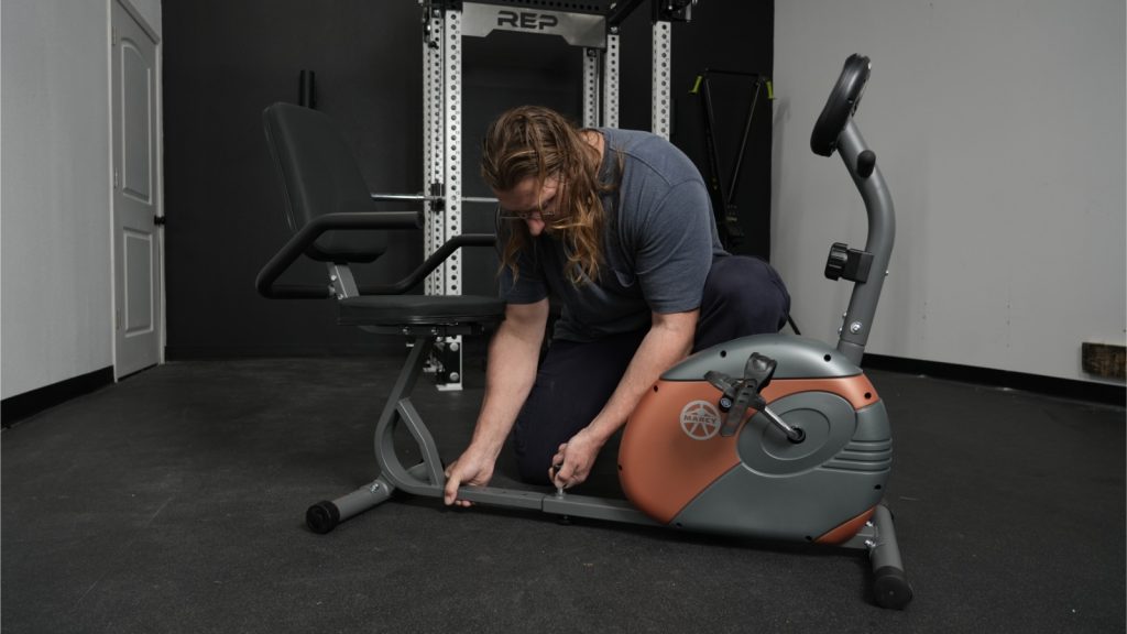 BarBend tester adjusting recumbent bike.