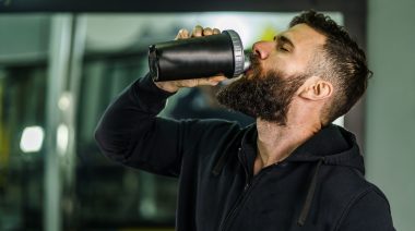 A person drinking a protein shake.