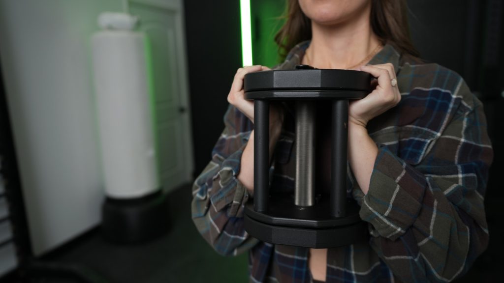 BarBend tester performing a goblet squat with the REP Fitness adjustable dumbbell.