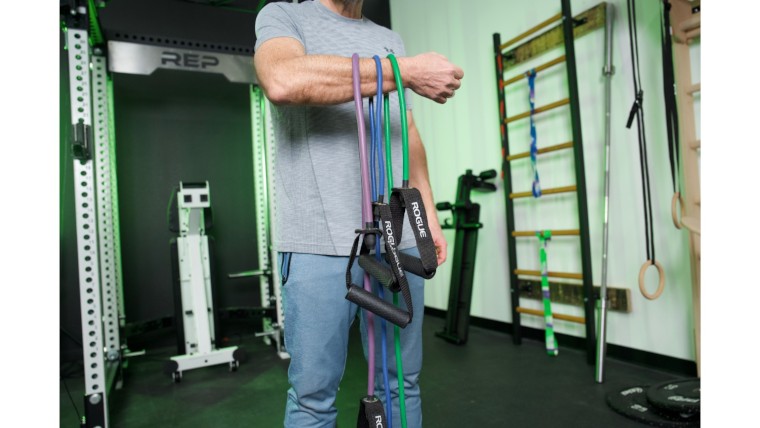 Rogue Tube Bands hanging from the arm of our BarBend Tester. 