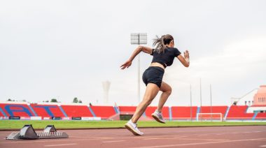 An athlete running on a running track.