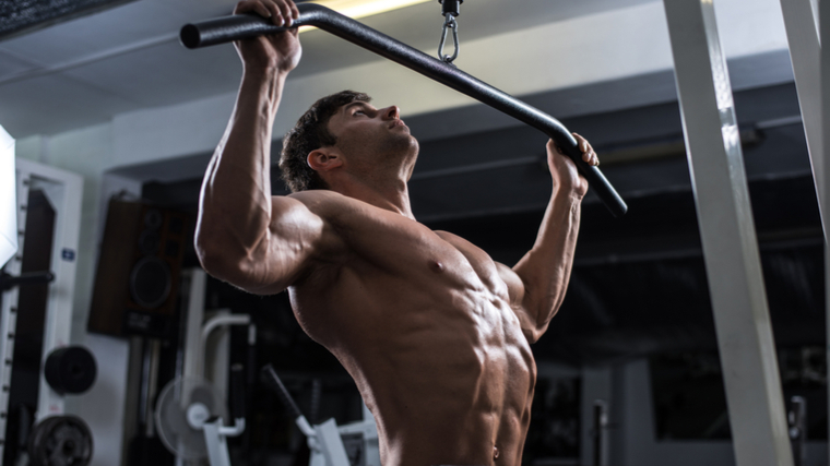 Man performs lat pulldown