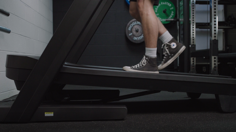 A BarBend tester using the incline on the Nordictrack Commercial 1750.