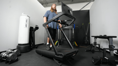 A person walking on the Peloton Tread treadmill.