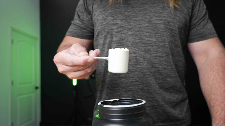 Our tester holding a scoop of supplement powder.