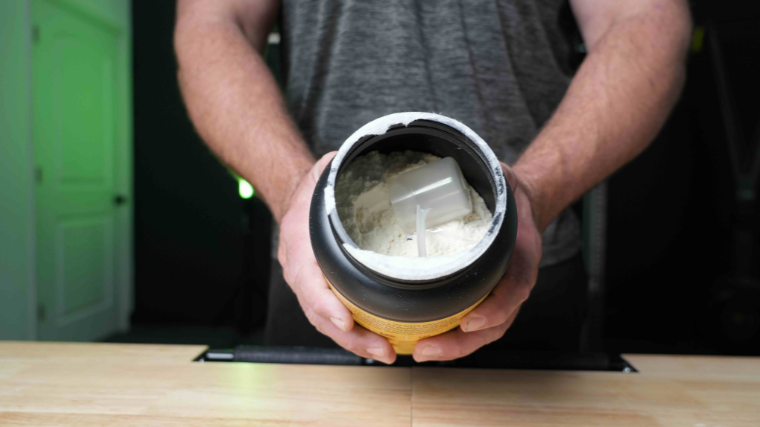 Our tester holding a container showing the supplement powder contents.