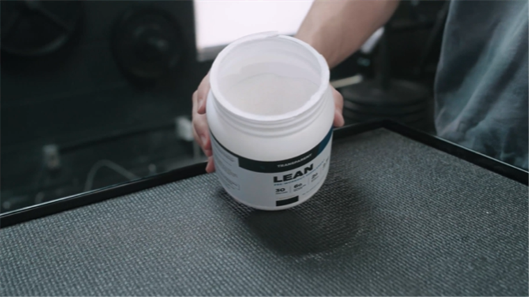 An opened tub of Transparent Labs LEAN Pre-Workout.